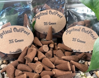May include: A close-up of a pile of brown incense cones. The cones are packaged in clear plastic bags with brown paper labels that read "Mystical Outpost" and "25 Cones".