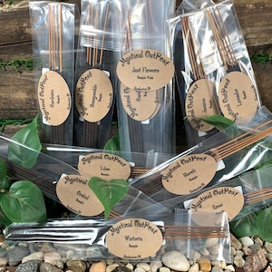 May include: A variety of incense sticks in clear plastic bags with brown paper labels. The labels have the text "Mystical OutPest" and the name of the scent, such as "Just Flowers", "Jasmine", "Lavender", "Gardenia", "Honeysuckle", "Orchid", "Lilac", "Wisteria", "Noreli", and "Resin".