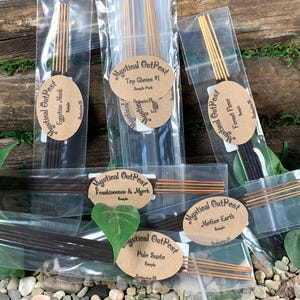 May include: Six small bags of incense sticks with brown paper labels. The labels have the text "Mystical OutPest" and the name of the scent. The scents are Egyptian Musk, Top Ghetee #1, Frankincense & Myrrh, Palo Santo, Mether Earth, and Forest Fleer.