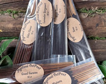 May include: Six clear plastic packages of incense sticks, each with a tan oval label reading Mystical OutPost, the scent name, 25 ct, and Rochester, IN. Scents include Elder Flower, Lavender Bergamot, Night Queen, Rose, Creed Carmina, and Wisteria.