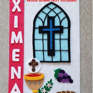 May include: A white felt banner with the name "XIMENA" in white letters on a red background. The banner also features a blue cross in a stained glass window, a chalice, a loaf of bread, and grapes. The text "Wood dowel NOT included" is written in red at the top of the banner.