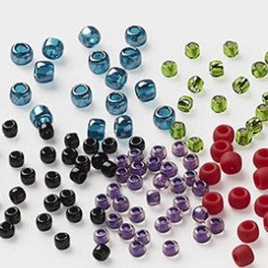 May include: Assortment of colourful glass beads in various shades of blue, green, red, black, and purple. The beads are small and round, perfect for jewellery making or crafting.