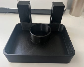 May include: A black 3D printed organizer with two vertical compartments and a circular cutout in the center.