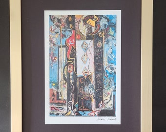 May include: A framed abstract painting with a black, white, red, blue, and yellow color scheme. The painting is signed "Jackson Pollock" in the bottom right corner.