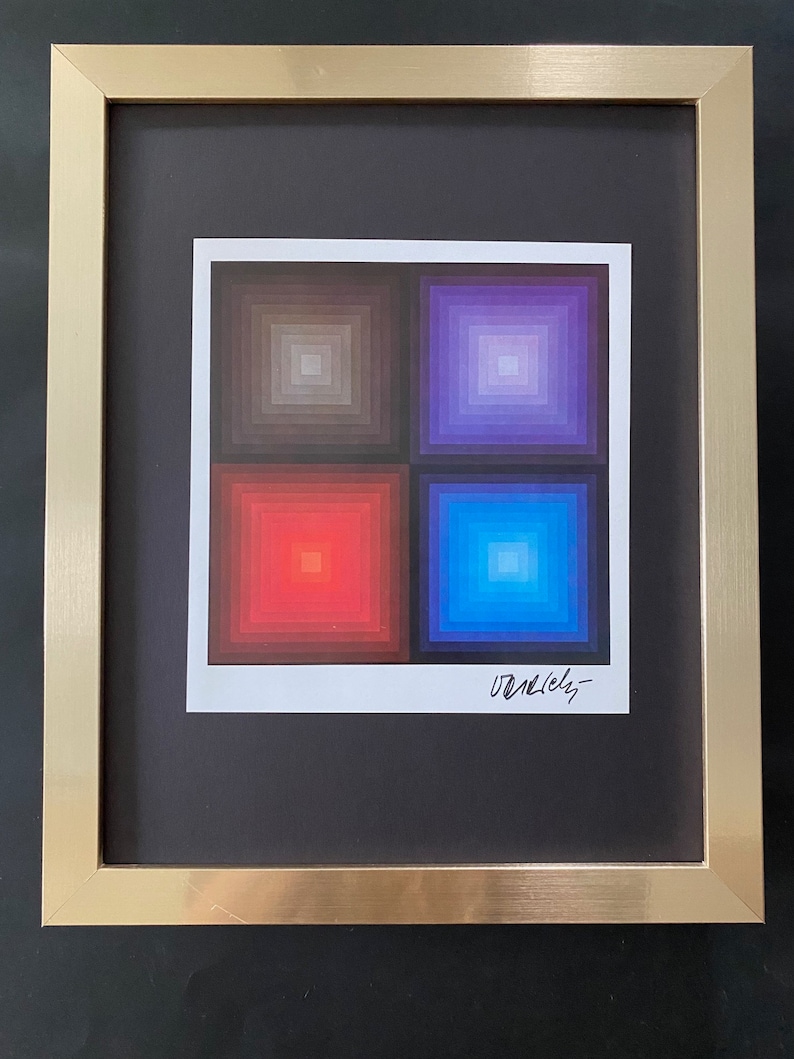 May include: A framed abstract art print with four squares of different colors. The top left square is a gradient of gray, the top right square is a gradient of purple, the bottom left square is a gradient of red, and the bottom right square is a gradient of blue. The print is signed "Varley".