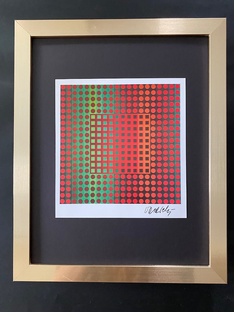 May include: A framed abstract art print with a geometric pattern of red, green, and brown circles. The print is signed "Vasarely".