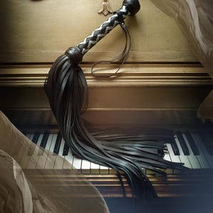 May include: A black leather whip with a white braided handle lies on the keys of an antique piano. A sheer fabric drapes over the piano.
