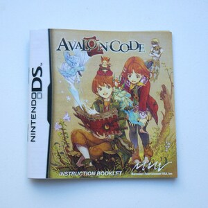 May include: A Nintendo DS instruction booklet for the game Avalon Code. The cover features a colorful illustration of two characters, a boy and a girl, in a fantasy setting.