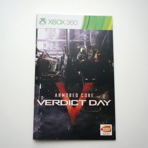Könnte beinhalten: Xbox 360-Spielecase für Armored Core Verdict Day. Das Case hat ein schwarzes und rotes Design mit einem Roboter im Hintergrund.