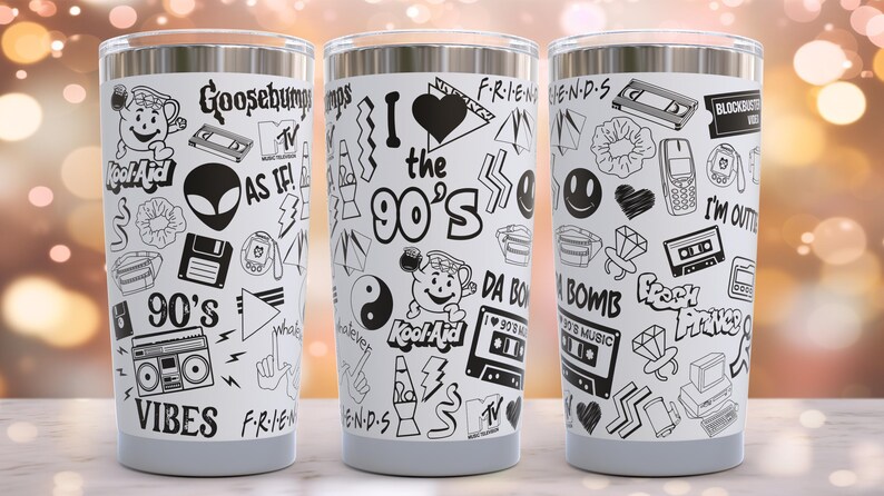 May include: Three stainless steel tumblers with a white background and black 90s themed graphics. The graphics include the words "I love the 90's", "Goosebumps", "90's Vibes", "Fresh Prince", "Da Bomb", "Kool-Aid", and "As If!"