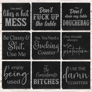 May include: Nine black slate coasters with humorous phrases engraved in white. The phrases include "likes a hot MESS", "Don't FUCK UP the table", and "USE THE damn COASTERS". These coasters are designed for home use.