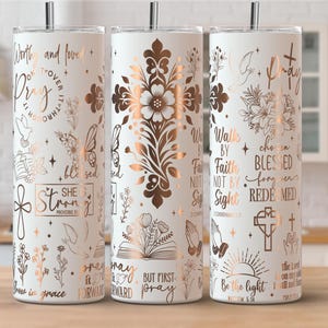 May include: White stainless steel tumbler with a copper floral design and inspirational text. The tumbler features a straw and is decorated with floral and cross motifs, and phrases like "Pray" and "Be the light."