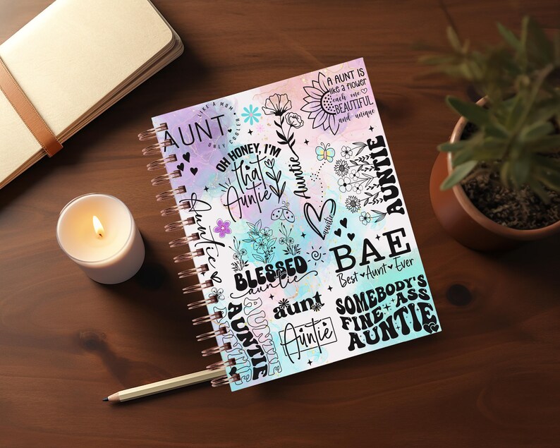 May include: A colorful spiral bound notebook with a watercolor background and black text that says "AUNT" and other phrases like "Oh honey, I'm that auntie", "Blessed auntie", "Bae Best Aunt Ever", "Somebody's Fine Ass Auntie".