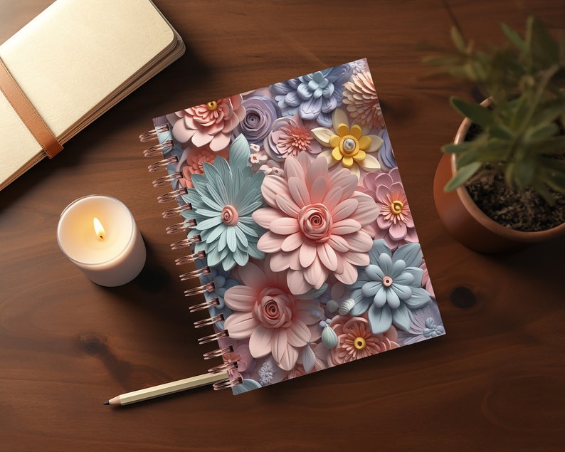 May include: A spiral bound notebook with a colorful floral design. The cover features pink, blue, and yellow paper flowers.
