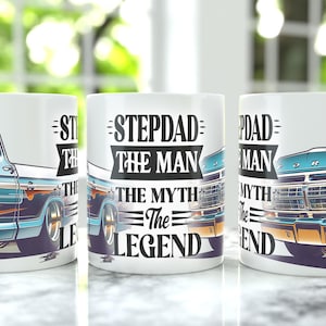 May include: White ceramic mug featuring a vintage truck design in shades of blue, orange, and white. The mug has the text "STEPDAD THE MAN THE MYTH THE LEGEND" in black. A great gift for stepdads.