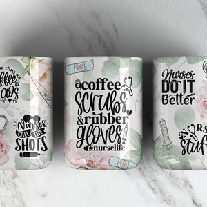 May include: Three white ceramic mugs with floral designs and black text. The mugs feature sayings related to nursing, such as "This nurse runs on coffee and chaos", "Coffee, Scrubs & Rubber Gloves #nurselife", and "Nurses Do It Better".