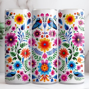 May include: Three white tumblers featuring a colourful floral and bird design. The design incorporates bright colours such as red, orange, yellow, blue, green, and pink.