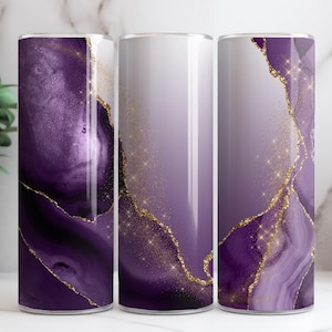 May include: Three stainless steel tumblers with a purple and gold abstract design. The design features a swirling pattern of purple and gold, resembling agate or marble.