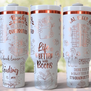 May include: White insulated travel mug with a handle, decorated with rose gold text and book-themed illustrations. The text includes "Books because reality is overrated", "Life is better with books", and "Eat. Sleep. Read."