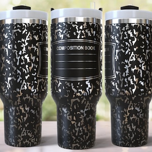 May include: Three stainless steel travel mugs with black lids and handles. The mugs are covered in a black and silver pattern that resembles a composition notebook. The middle mug has the text "COMPOSITION BOOK" printed on it.
