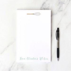 May include: White notepad with a wire whisk illustration and the text "From Claundra's Kitchen" at the bottom.