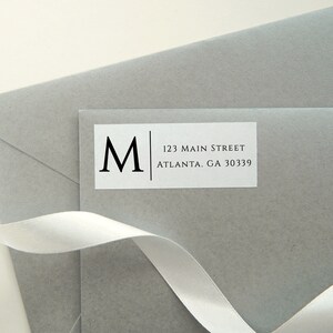 May include: A white return address label with a black letter "M" and the text "123 Main Street Atlanta, GA 30339".