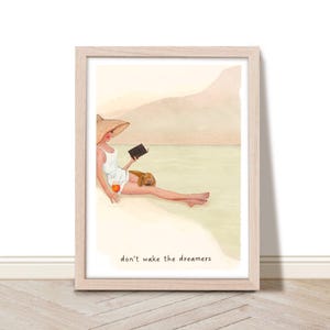 May include: A watercolor illustration of a woman wearing a straw hat and a white dress, sitting on a beach with a dog and reading a book. The text "don't wake the dreamers" is written below the image.