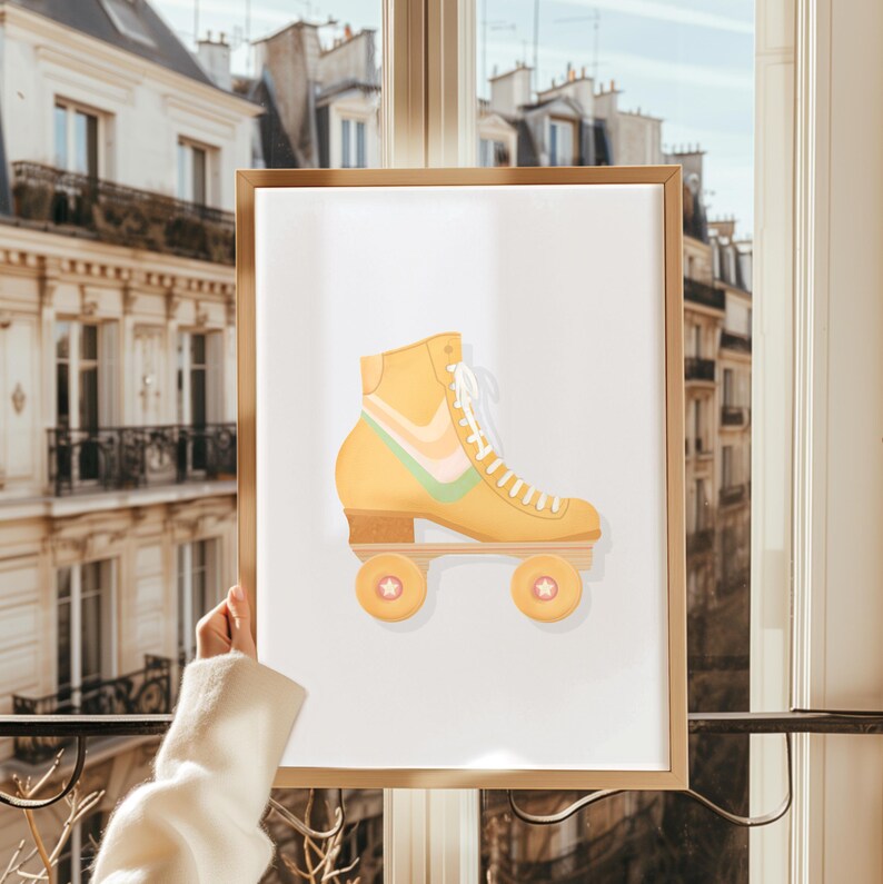 May include: A framed print of a yellow roller skate with pastel pink and green accents. The skate has white laces and wheels with a white star design.