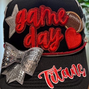 Black and white checkered trucker hat in a football theme.  Ladies.  Titans. Checkered mesh. Multiple patches. Silver embellishments.