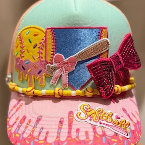 May include: A white ceramic mug with a black handle and the text "But First, Coffee" in a black, bold font. The mug is on a white surface.