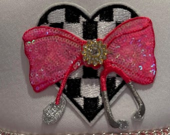 Pink and white trucker hat in medical theme .