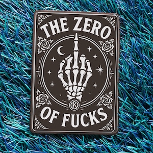 May include: A rectangular sign with a dark brown background and white text. The text reads "THE ZERO OF FUCKS" with a skeleton hand giving the middle finger in the center. The design includes roses, stars, and a crescent moon.