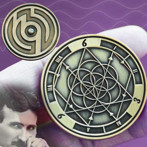 May include: Two gold-toned metal coins with geometric designs. The first coin features a circular maze pattern with a small dot in the center. The second coin features a black and white geometric design with Roman numerals around the edge. The numbers 6 and 3 are visible on the coin.