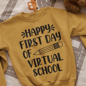 May include: A mustard yellow sweatshirt with the text "Happy First Day of Virtual School" and a black pencil graphic.