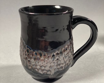 Glossy black and copper carved ceramic mugs