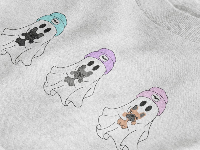 May include: Three cartoon ghost illustrations with French bulldog faces and holding teddy bears. Each ghost wears a beanie with a bat symbol. The beanies are light blue, lavender, and pink. The ghosts are on a white background.