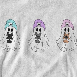 May include: Three cartoon ghosts wearing beanies in blue, purple, and pink, each holding a French bulldog. The ghosts have black eyes and are outlined in black. The beanies have a bat symbol. The image is on a white background.