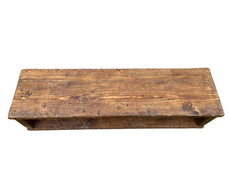 Puede incluir: Estanter&iacute;a rectangular de madera r&uacute;stica con acabado natural envejecido. La estanter&iacute;a es de color marr&oacute;n c&aacute;lido, con vetas y nudos de madera visibles. Cuenta con una balda inferior para almacenamiento adicional. Ideal para exhibir objetos.