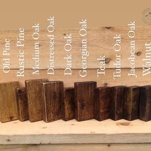 May include: Ten wood stain samples in various shades of brown, including Old Pine, Rustic Pine, Medium Oak, Distressed Oak, Dark Oak, Georgian Oak, Teak, Tudor Oak, Jacobean Oak, and Walnut.