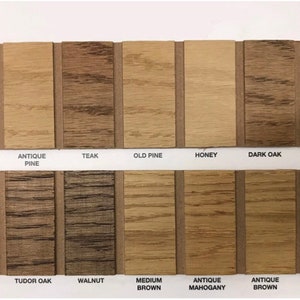 May include: Wood stain color chart with 14 different wood stain colors. The colors are labeled with names like "Clear", "Antique Pine", "Teak", "Old Pine", "Honey", "Dark Oak", "Jacobean", "Rustic Pine", "Tudor Oak", "Walnut", "Medium Brown", "Antique Mahogany", "Antique Brown", and "Spanish Mahogany".