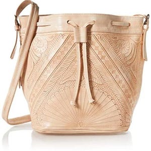 May include: A light brown leather bucket bag with a drawstring closure and a long shoulder strap. The bag has intricate embossed floral patterns.