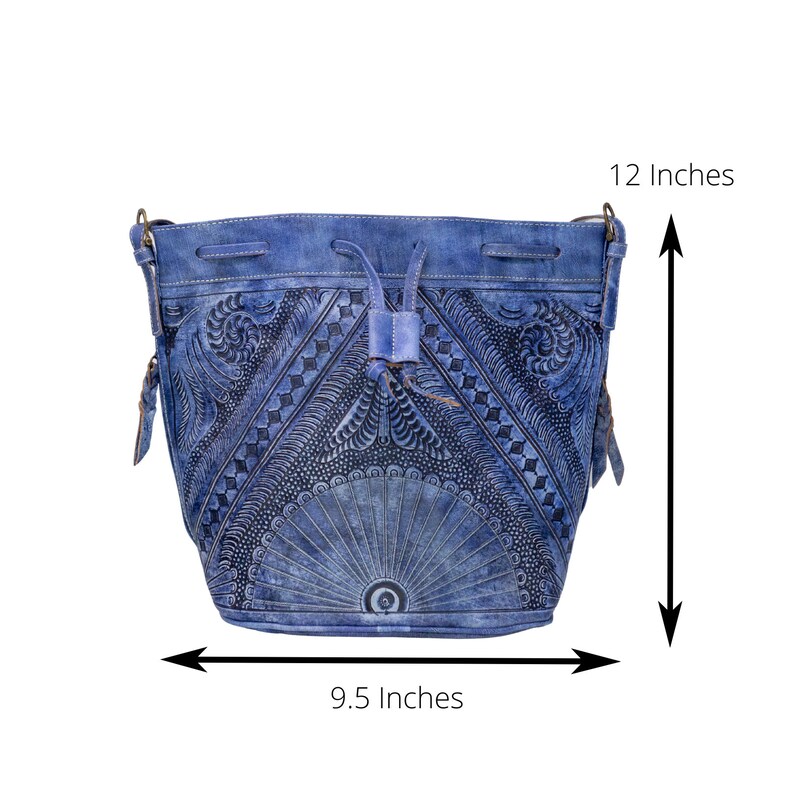 May include: A blue leather bucket bag with intricate embossed floral designs. The bag has a drawstring closure and a shoulder strap. It measures 9.5 inches wide and 12 inches tall.