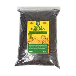 May include: A clear plastic bag filled with dark brown substrate. The bag features a yellow and green label with the text "BUGZY'S DESERTSCAPE SUBSTRATE" and an illustration of a desert scene with a lizard. The label also states "Natural Desert Terrain for Bearded Dragons, Leopard Geckos & Uromastyx."