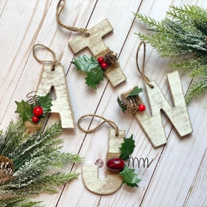 White washed distressed wood letter Christmas ornament with floral.