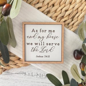 May include: A wooden sign with the text "As for me and my house we will serve the Lord" and the scripture reference "Joshua 24:15".