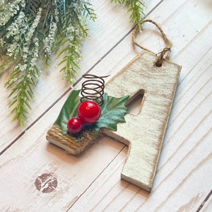 White washed distressed wood letter Christmas ornament with floral.