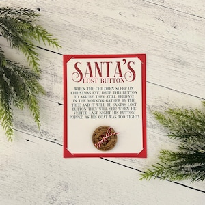 May include: A red and white card with the text "SANTA'S LOST BUTTON" and instructions for a Christmas Eve tradition. The card features a wooden button with a red and white candy cane design.