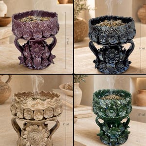 May include: A set of four ceramic incense burners, each 8 inches tall, featuring a bowl with a scalloped rim and a base decorated with sculpted flowers and leaves. The burners are finished in glossy purple, black, beige, and dark green glazes.
