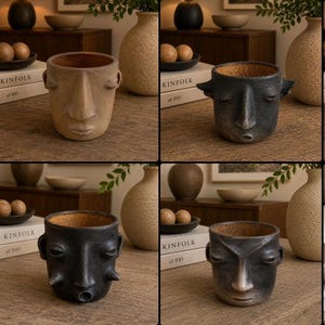 May include: A collection of four ceramic planters, each featuring a unique human face design. The planters are rendered in various shades of matte beige, charcoal, and black, with textured surfaces and distinct facial expressions including closed eyes.