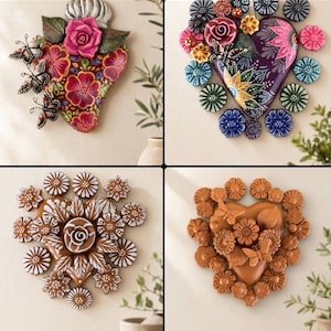 May include: A collection of four heart-shaped wall plaques featuring floral and butterfly motifs. Each plaque displays distinct color palettes including pink, purple, brown, and terracotta, with intricate painted details and dimensional flower accents.